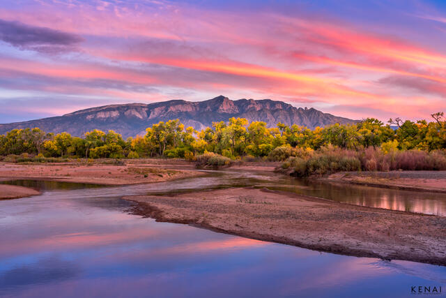 Pink, colorful sunset over the Sand Mountain Range and Rio Grande near Albuquerque, New Mexico.