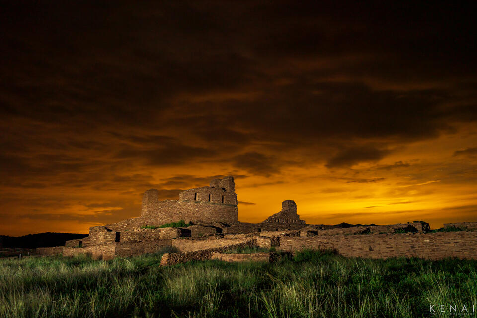 City lights illuminate the sky above the Salt Mission Ruins of Abo, New Mexico in this night photo. 