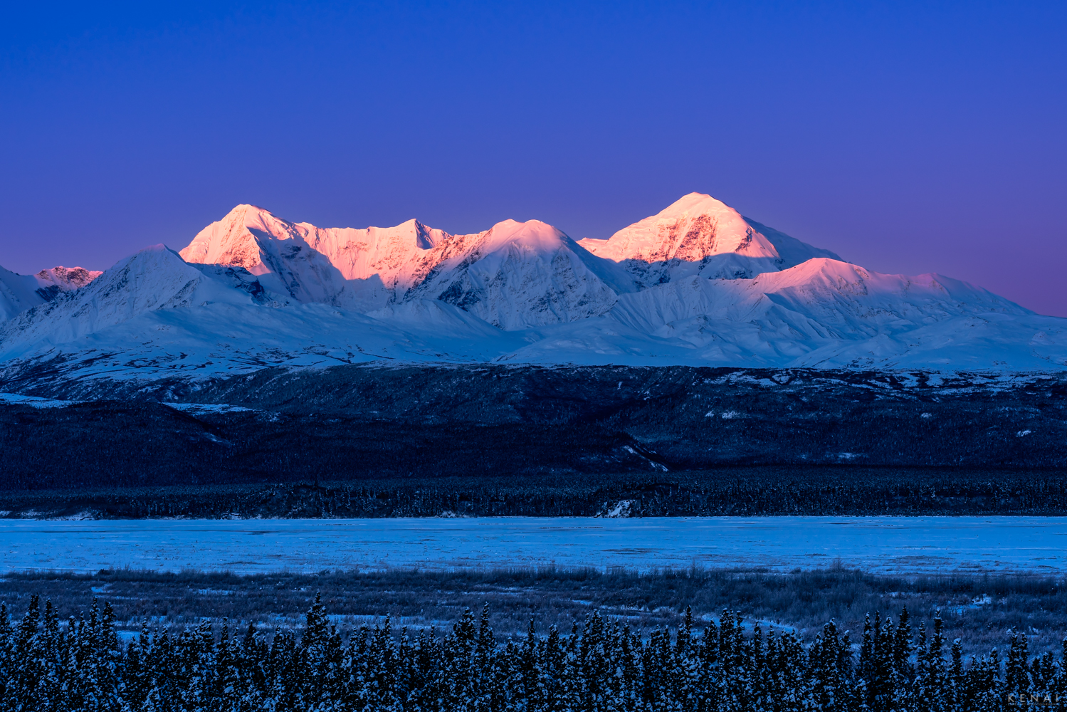 Dawn descends on the mountains of the eastern Alaska Range. 